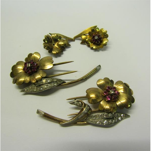 198 - A suite of gold Diamond and Ruby set jewellery comprising a matching pair of two petal and leaf form... 