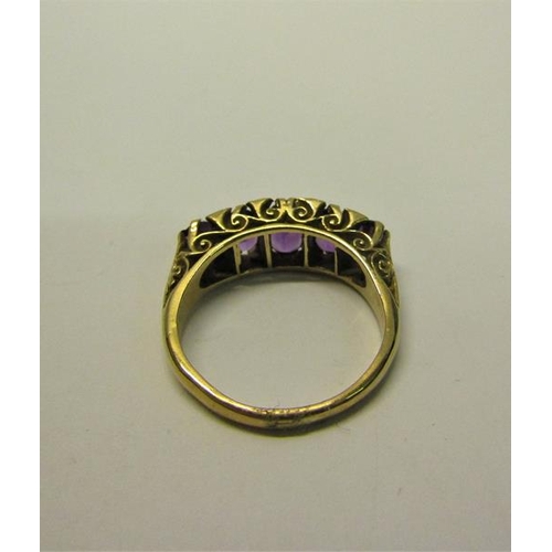 210 - A gold five stone ring set with five cut Amethysts.  Ring size P/Q.