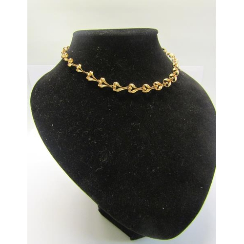 215 - A 9ct gold necklace of linked form - 36cms l. 13.g.