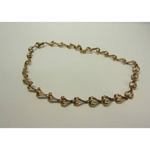 215 - A 9ct gold necklace of linked form - 36cms l. 13.g.