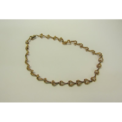 215 - A 9ct gold necklace of linked form - 36cms l. 13.g.