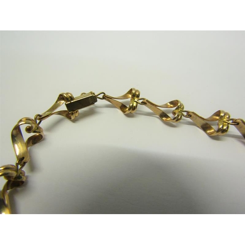 215 - A 9ct gold necklace of linked form - 36cms l. 13.g.