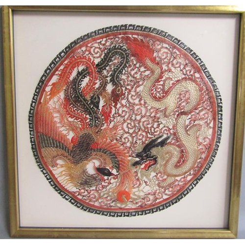 415 - A Vietnamese buffalo hide of circular form depicting a dragon and a mythical bird with gilt highligh... 