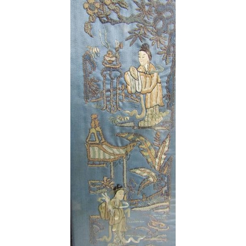 416 - A pair of late 19th century Oriental blue silk panels, the silkwork depicting four ladies in garden ... 