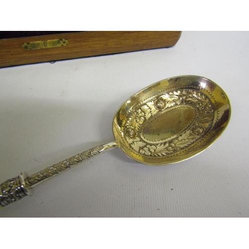 321 - A pair of Victorian silver plated serving spoons with gilt lined bowls, chased with bands of leaf an... 