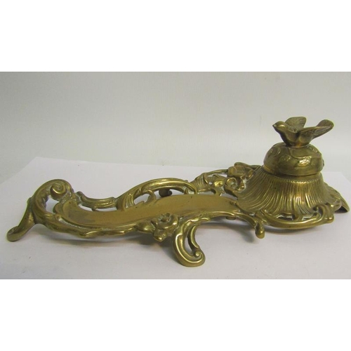 40 - A late Victorian cast brass ink stand with single well under a domed cover with bird finial, with pe... 