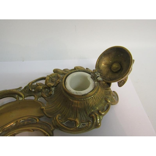 40 - A late Victorian cast brass ink stand with single well under a domed cover with bird finial, with pe... 