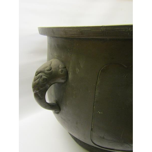 46 - A 19c Oriental patinated bronze jardinere of bulbous form with Elephant trunk side handles and panel... 