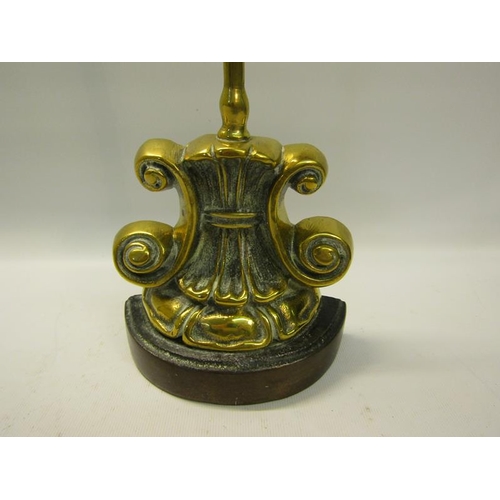 49 - A 19c brass and iron doorstop with central carry handle.  38cms h.