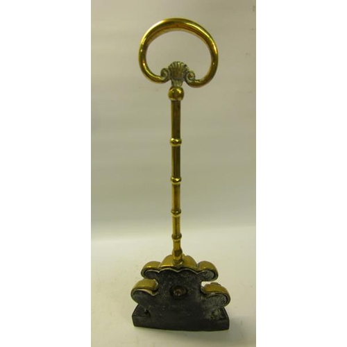 49 - A 19c brass and iron doorstop with central carry handle.  38cms h.