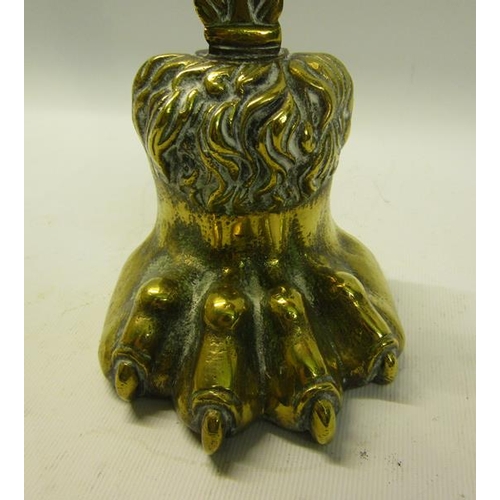 50 - A 19c brass and iron lion paw door stop with a leaf form carrying handle.  39cms h.