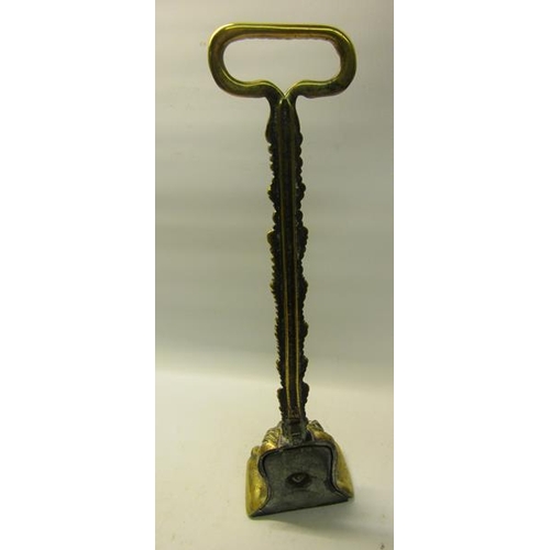 50 - A 19c brass and iron lion paw door stop with a leaf form carrying handle.  39cms h.