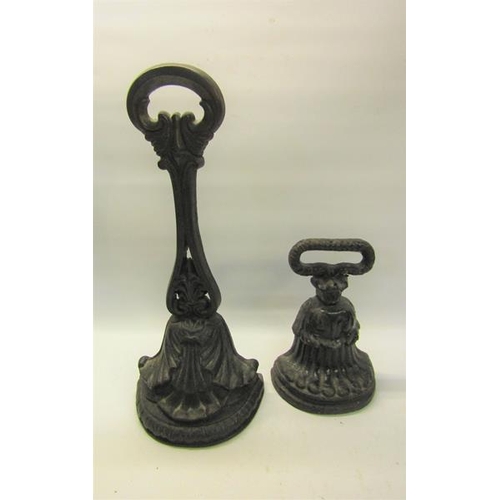 52 - A 19c Kenrick cast iron door stop 34cms h, together with a similar 18cms h.