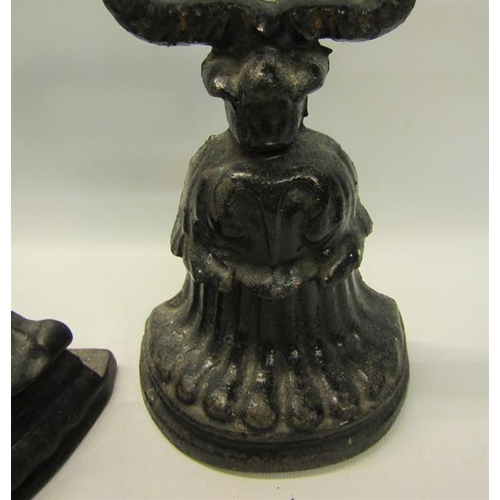 52 - A 19c Kenrick cast iron door stop 34cms h, together with a similar 18cms h.