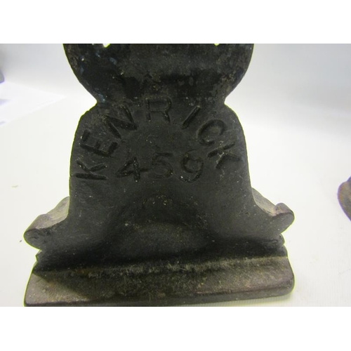 52 - A 19c Kenrick cast iron door stop 34cms h, together with a similar 18cms h.