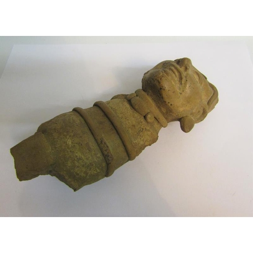 70 - A fragment of a pre-Colombian pottery figure with arms and legs missing and ear lobe, 19cms l.  Toge... 