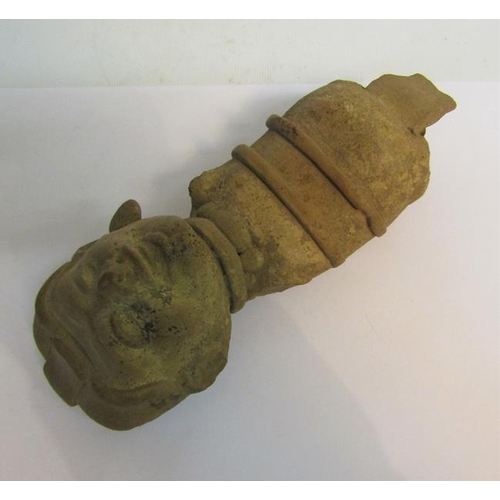 70 - A fragment of a pre-Colombian pottery figure with arms and legs missing and ear lobe, 19cms l.  Toge... 