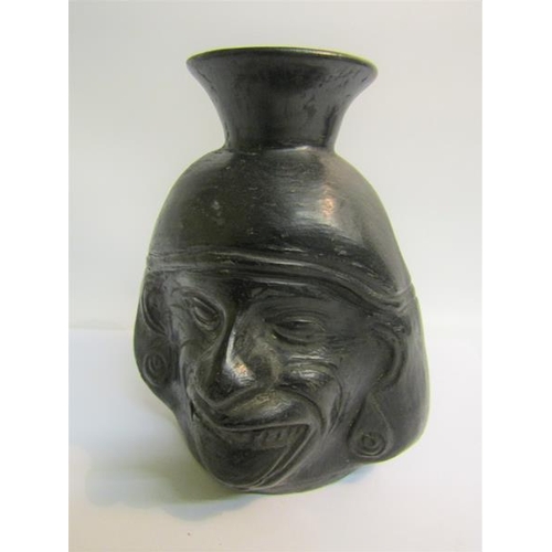 74 - A Raku style pottery facial vase, 16cms h.