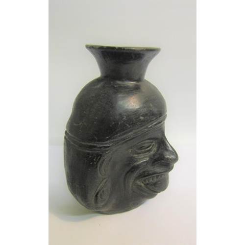 74 - A Raku style pottery facial vase, 16cms h.