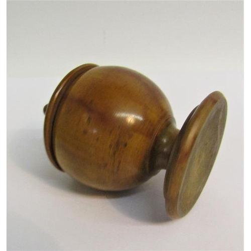 92 - A 19c Fruitwood nutmeg grater in the form of a turned wood cup on stand with lift of cover carrying ... 