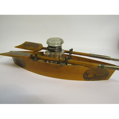 94 - An early 20c Mauchline Ware rowing boat single bottle inkstand, a blade of the oar with printed pane... 