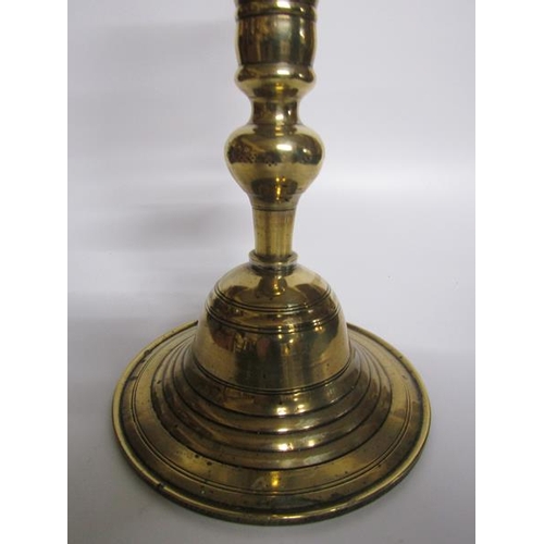 56 - An 18c bronze bell base candlestick with a knop double column with central drip pan and baluster soc... 