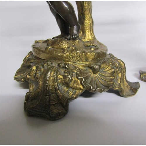 60 - A pair of late 19c gilt and patinated bronze candlesticks with putti columns supporting the socles a... 