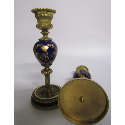 63 - A pair of late 19c ormolu and ceramic candlesticks, the ceramic knops with jewelled gilt wreath desi... 