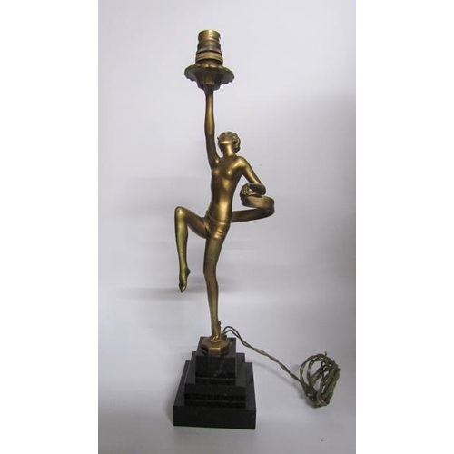 64 - An art deco gilt metal dancing figure table lamp supported on stepped marble base, electrolier.  The... 