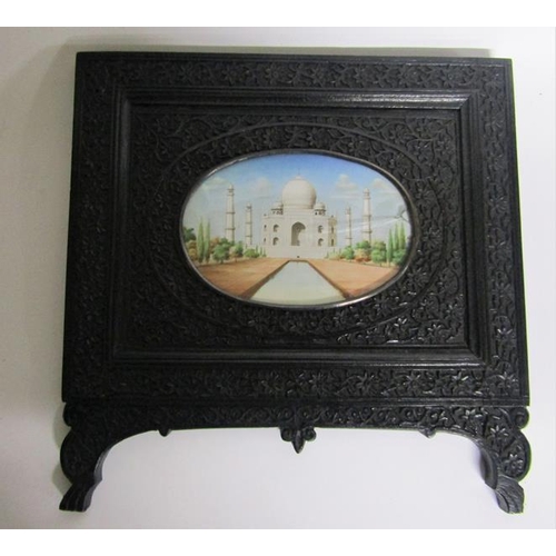 65 - Late 19c Indian oval painted miniatures of the Taj Mahal and Qutub Minar Tower, both in carved ebony... 