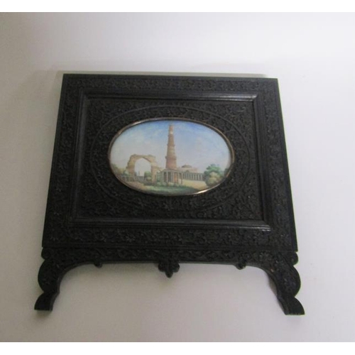 65 - Late 19c Indian oval painted miniatures of the Taj Mahal and Qutub Minar Tower, both in carved ebony... 