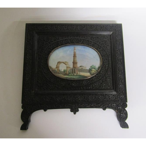 65 - Late 19c Indian oval painted miniatures of the Taj Mahal and Qutub Minar Tower, both in carved ebony... 