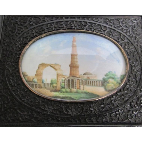 65 - Late 19c Indian oval painted miniatures of the Taj Mahal and Qutub Minar Tower, both in carved ebony... 