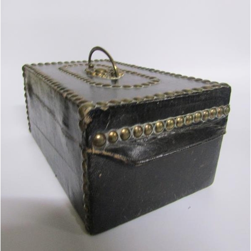 78 - A George III leather and brass studded small trunk, paper lined and with a label Charles M Domett.  ... 