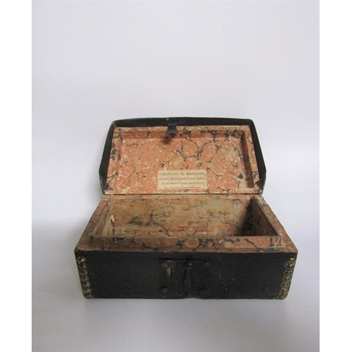 78 - A George III leather and brass studded small trunk, paper lined and with a label Charles M Domett.  ... 