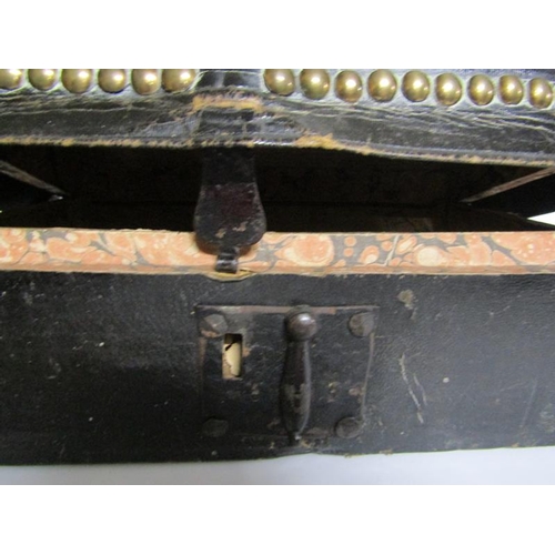 78 - A George III leather and brass studded small trunk, paper lined and with a label Charles M Domett.  ... 