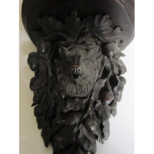 82 - A 19c Black Forest acorn and oak leaf carved wall bracket with a boars head mask.  28cm w x 39cm h.