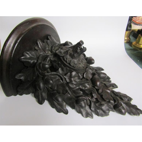 82 - A 19c Black Forest acorn and oak leaf carved wall bracket with a boars head mask.  28cm w x 39cm h.