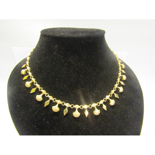 213 - An 18ct gold necklace with pendant drops and diamond shaped links.  40cms l. 18g.