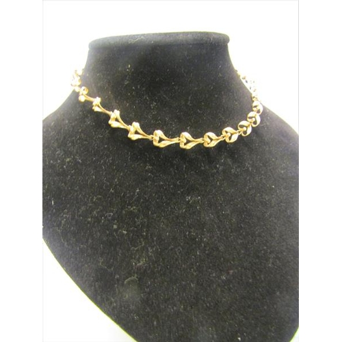 215 - A 9ct gold necklace of linked form - 36cms l. 13.g.