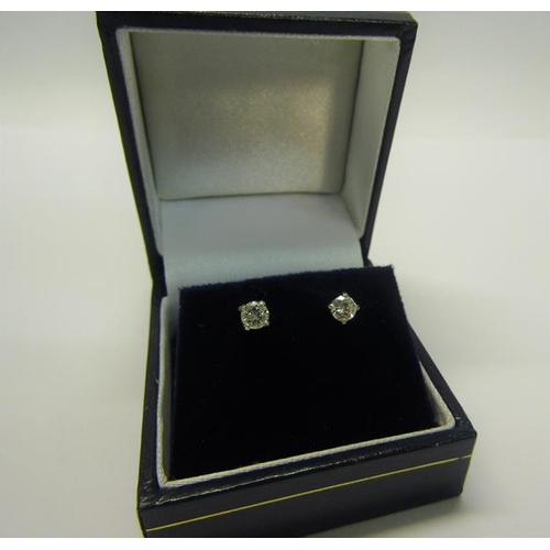 216 - An 18ct gold diamond stud earrings, approx 1/2 carat total.