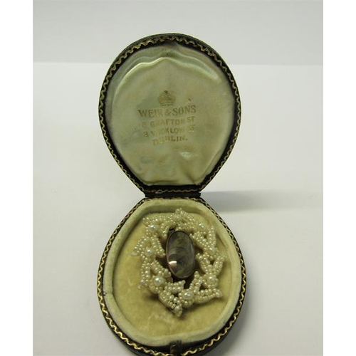 161 - A Victorian memoriam seed pearl brooch with locket of hair insert.