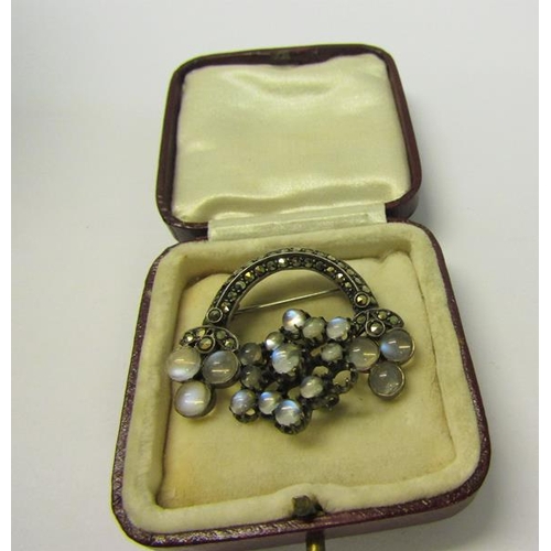 164 - An early 20c marcasite and moonstone set crescent brooch together with a pendant brooch of circular ... 