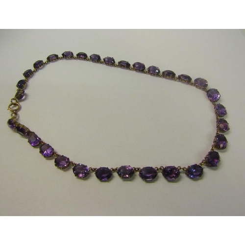 166 - A late 19/early 20c gold Amethyst set Riviere necklace set with twenty one graduated cut stones.  40... 