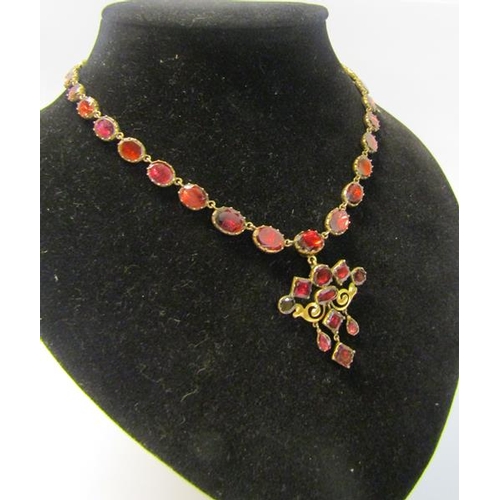 170 - A gold and Spinel set necklet with pendant, 40cms l. weight 26.2g.