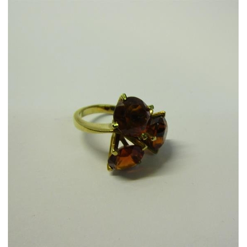 177 - An 18ct gold cut Garnet three stone set ring - ring size J/K