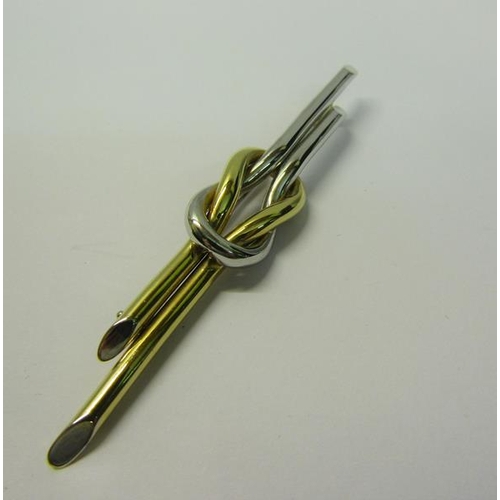 179 - An art deco style 18ct two colour gold bar brooch, 7.5cms l. 6g.