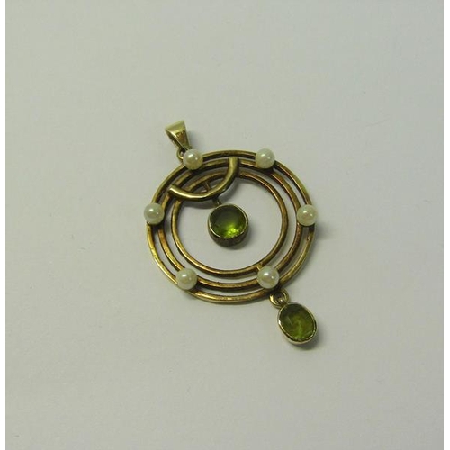 181 - A gold Seed Pearl and Peridot set pendant, 2.5cms dia.