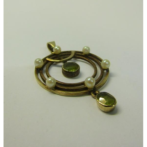 181 - A gold Seed Pearl and Peridot set pendant, 2.5cms dia.