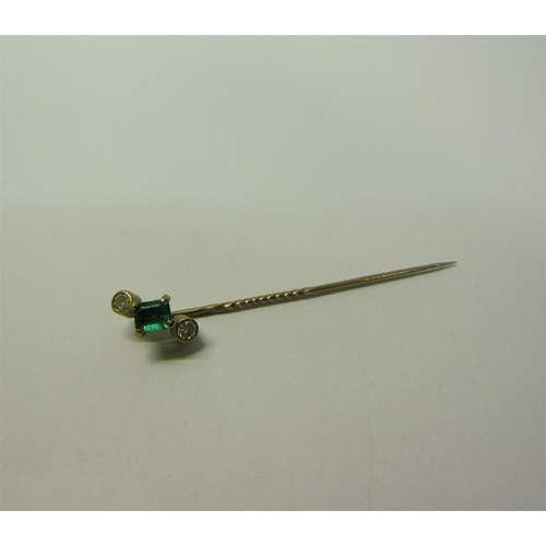 186 - A gold Emerald and Diamond set stick pin, 5.5cms l.